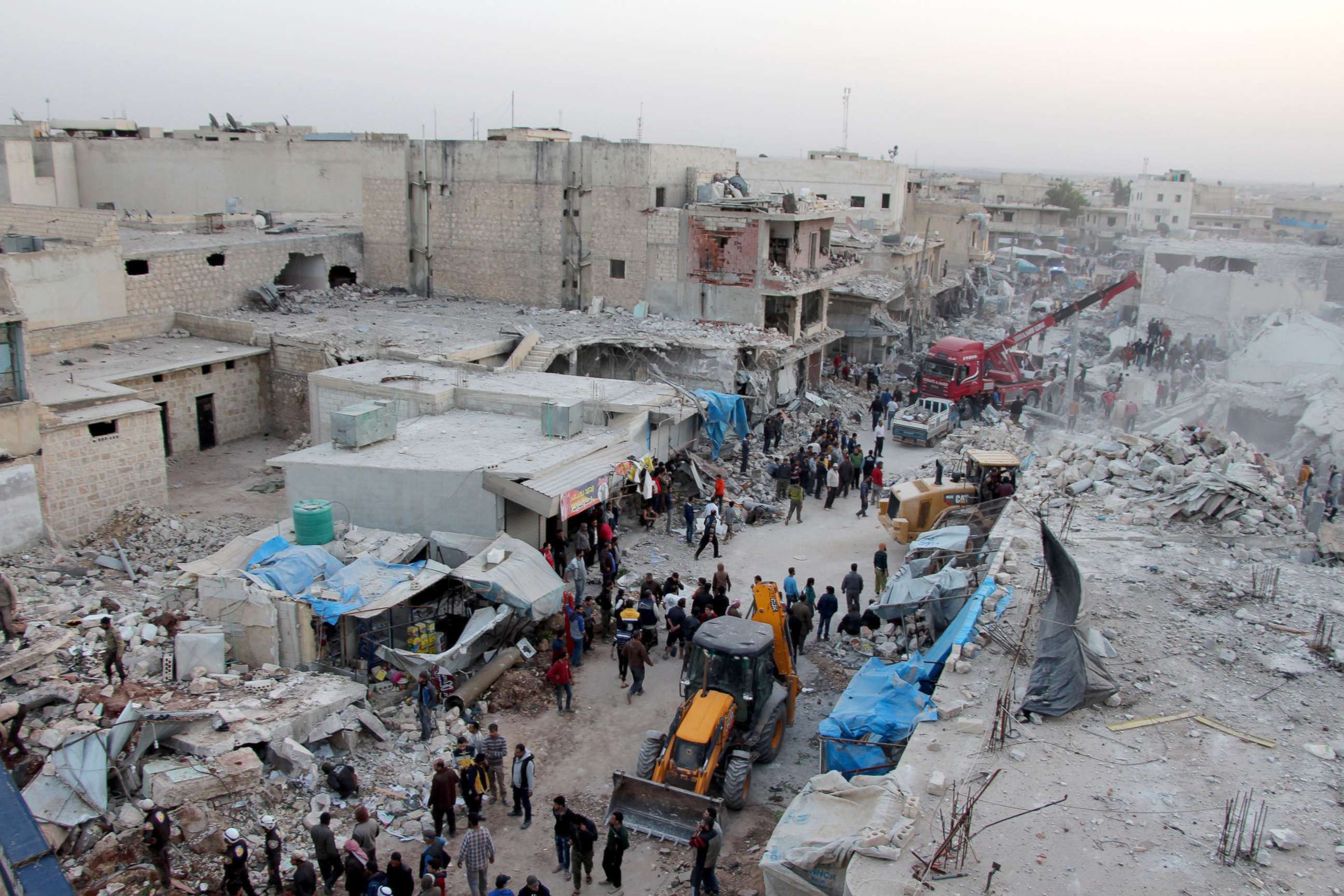 PHOTO: Search and rescue team conducts a rescue operation after the airstrikes that targeted a marketplace, where approximately 100 people were present in the opposition-held town of Atarib in Syrias northwestern Aleppo province, Nov. 13, 2017.