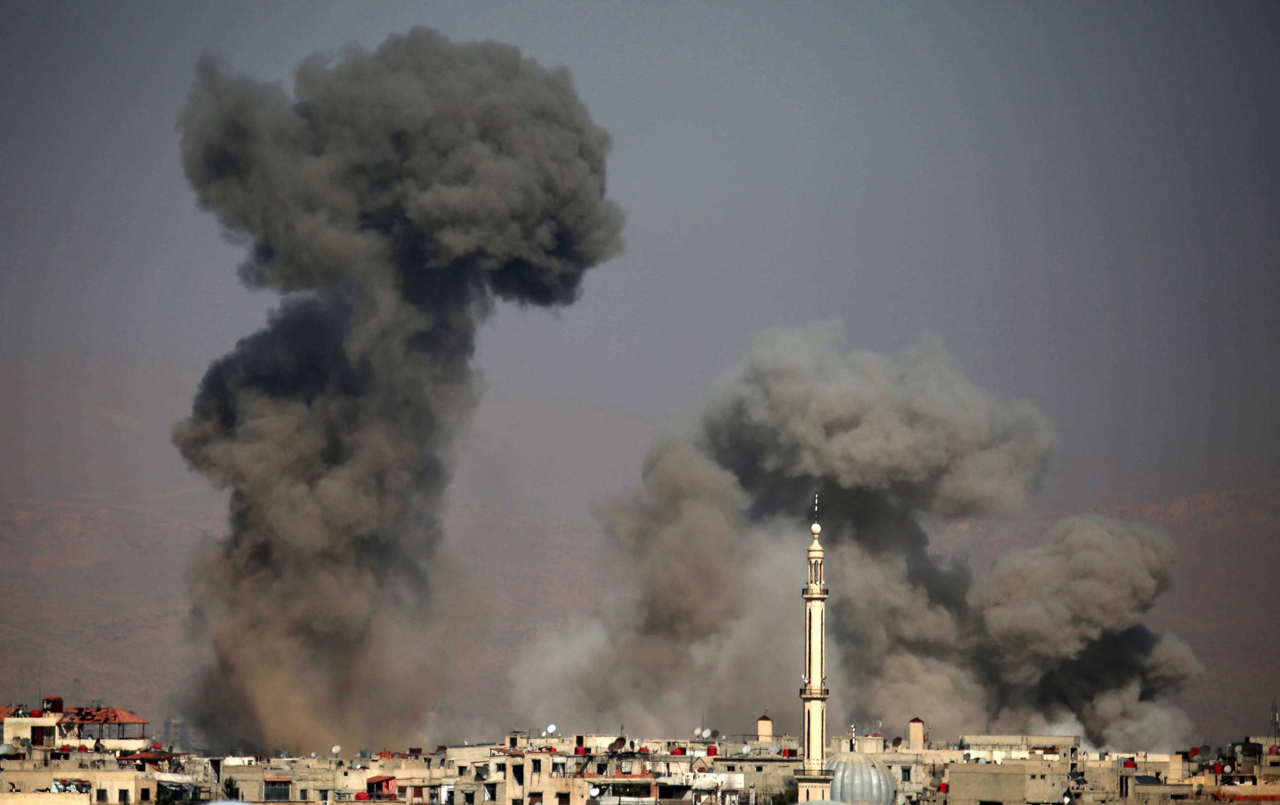 PHOTO: Plumes rise following a reported regime air strike in the rebel-held town of Arbin, in the besieged Eastern Ghouta region on the outskirts of the capital Damascus, Feb. 7, 2018. 