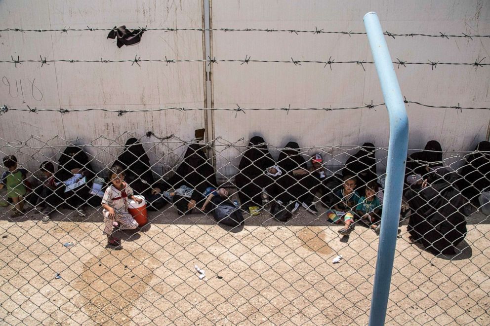 PHOTO: Women and children related to fighters of the Islamic State group wait to board buses and trucks, leaving the overcrowded al-Hol camp to return to their homes, June 3, 2019, in Hasakeh, Syria.