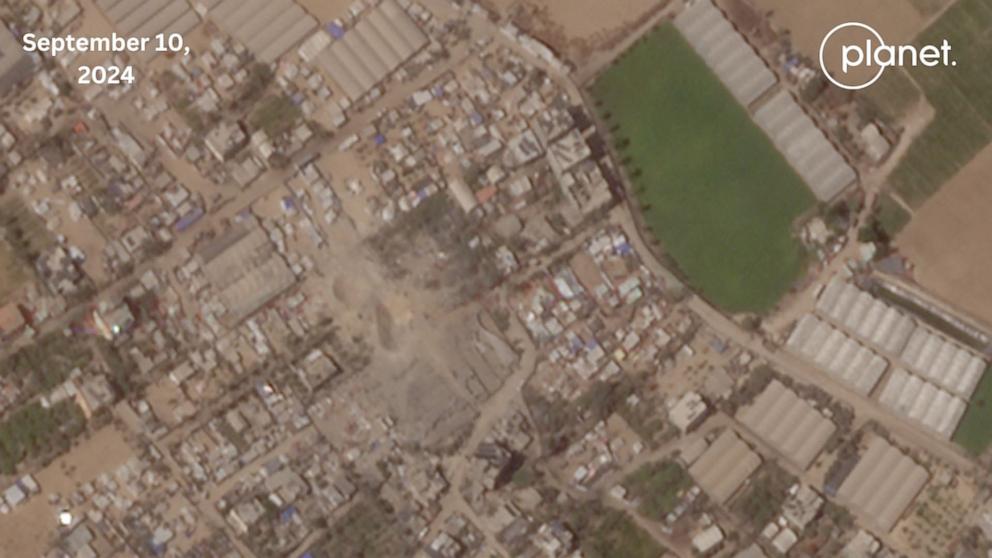 PHOTO: Photo captured from the site of the deadly strike shows two large craters with fabric and debris buried in the sand.