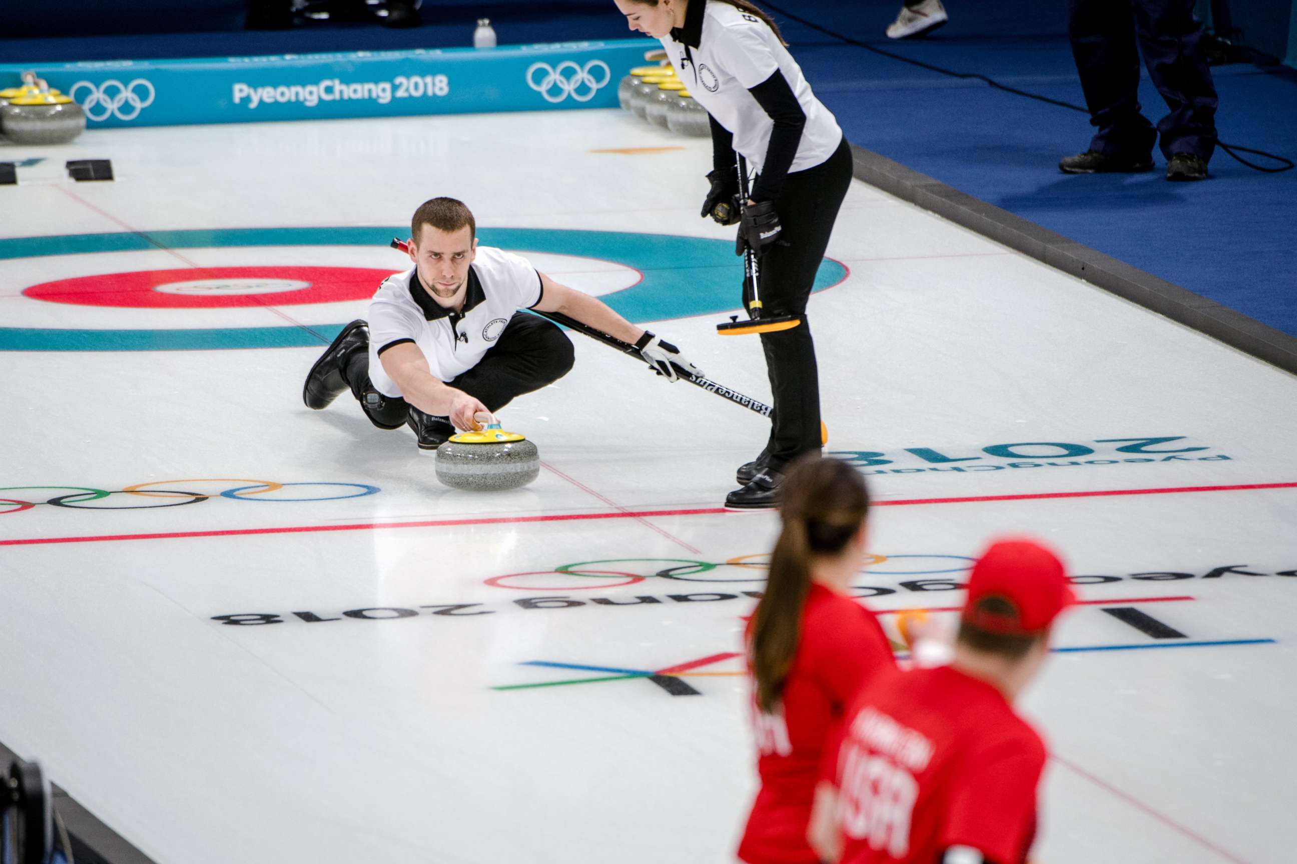PHOTO: The Russian athletes Aleksandr Krushelnitcki and Anastasia Bryzgalova in action against the American siblings Matt and Becca Hamilton, in the mixed doubles curling event at the Gangneung Curling Center in Gangneung, South Korea, Feb. 8, 2018. 