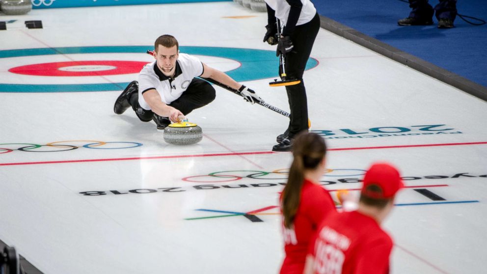 The Russian athletes Aleksandr Krushelnitcki and Anastasia Bryzgalova in action against the American siblings Matt and Becca Hamilton, backs to camera, in the mixed doubles curling event at the Gangneung Curling Center in Gangneung, South Korea, Feb. 8, 2018.