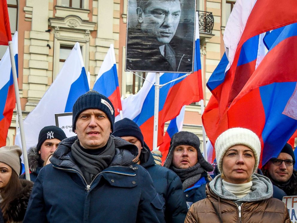 PHOTO: Russian opposition leader Alexey Navalny (L) and his wife Yulia (R) attend an opposition march in memory of murdered Kremlin critic Boris Nemtsov in central Moscow, Feb. 25, 2018.