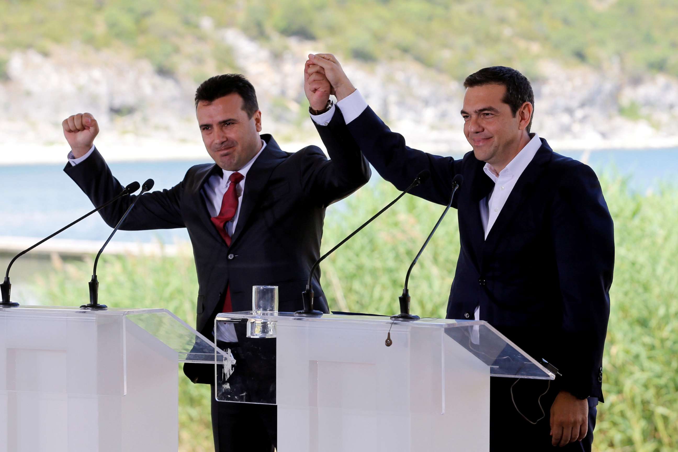 PHOTO: Greek Prime Minister Alexis Tsipras and Macedonian Prime Minister Zoran Zaev gesture before the signing of an accord to settle a long dispute over the former Yugoslav republic's name in the village of Psarades, in Prespes, Greece, June 17, 2018.