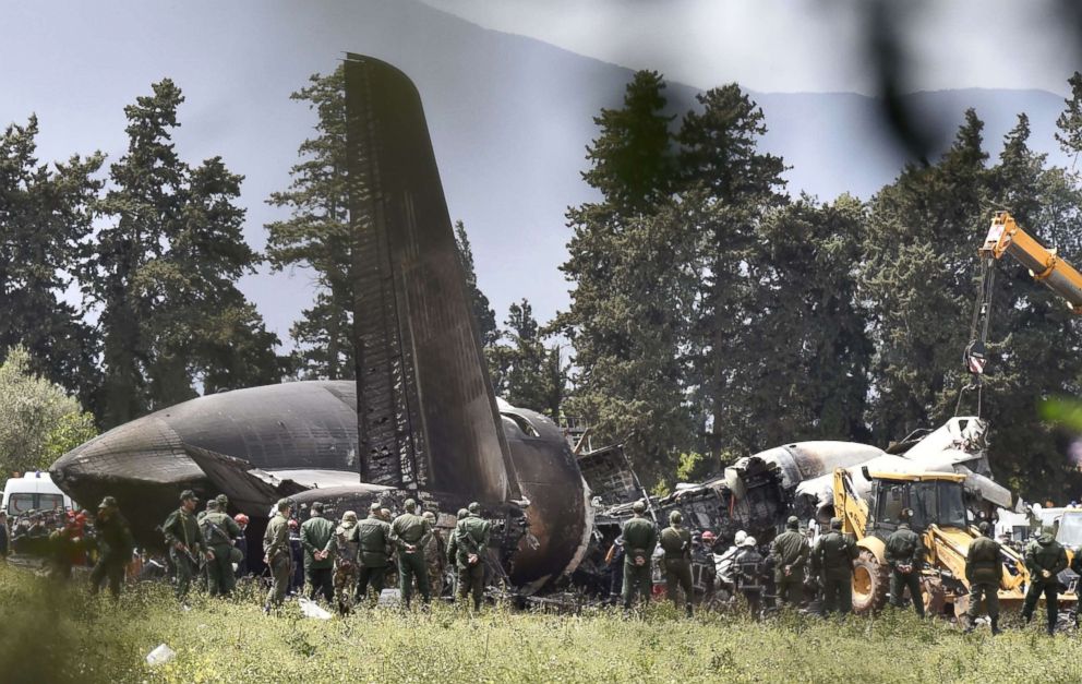 PHOTO: Rescuers are seen around the wreckage of an Algerian army plane which crashed near the Boufarik airbase from where the plane had taken off on April 11, 2018.