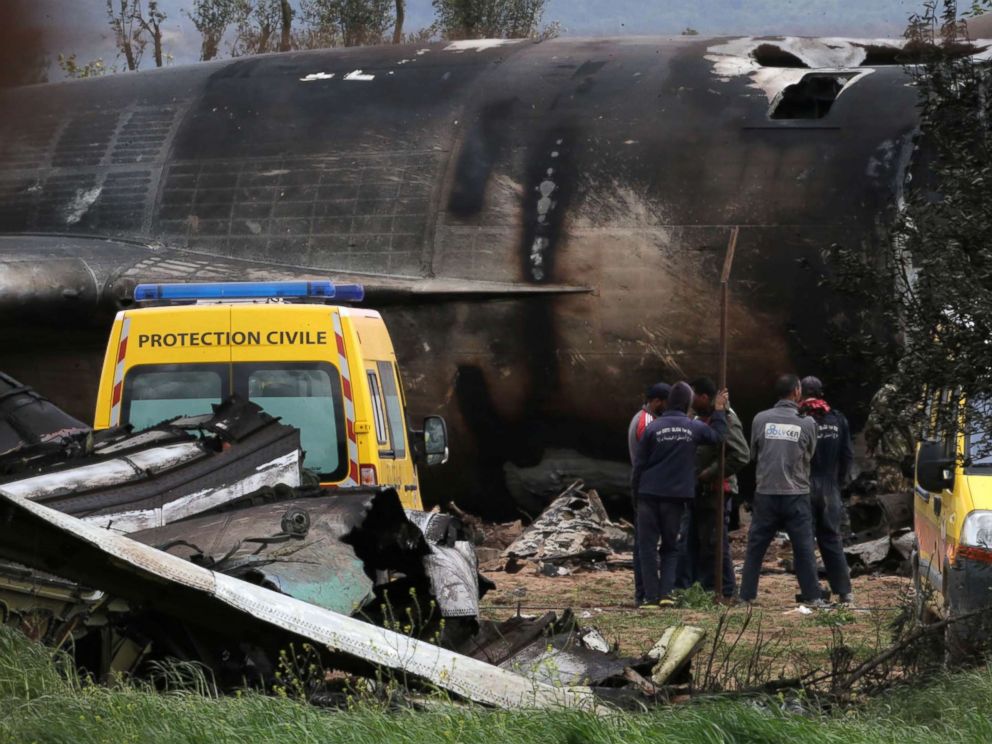 PHOTO: Algerian rescuers stand next to the wreckage of a military transport aircraft that crashed in Boufarik, near the Algeria capitol, Algiers, April 11, 2018.