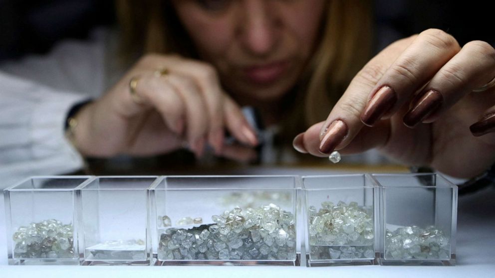 FILE PHOTO: An employee sorts rough diamonds at a sorting center, owned by Russian diamond mining company Alrosa, in Moscow, Russia, on Oct. 18, 2013.