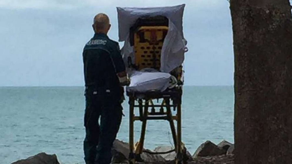 The Queensland Ambulance Service posted this photo to their Facebook after granting a terminally ill woman in Australia her final wish to go to the beach.