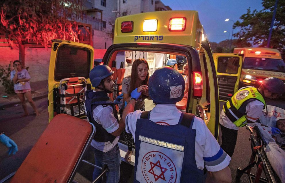 PHOTO: Rescue workers evacuate a woman by ambulance, amidst a rocket attack from the Gaza Strip, in the southern Israeli city of Sderot, May 12, 2021.