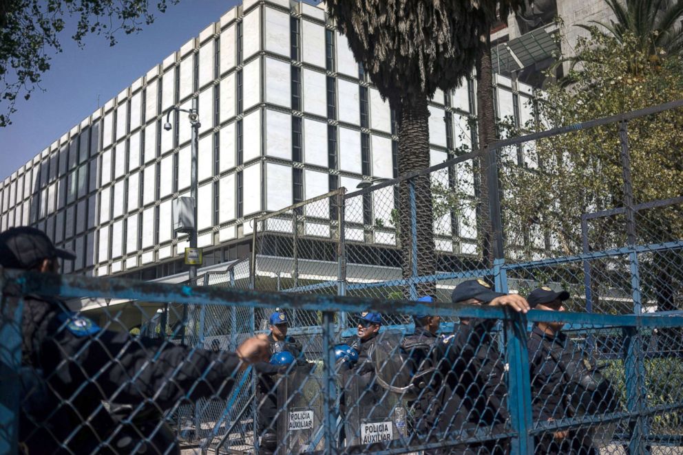 PHOTO: Police officers stand guard outside of the American Embassy as demonstrators protest to demand the Mexican government defend the country in the face of President's Donald Trump's threats to economic policy in Mexico City, Feb. 12, 2017. 