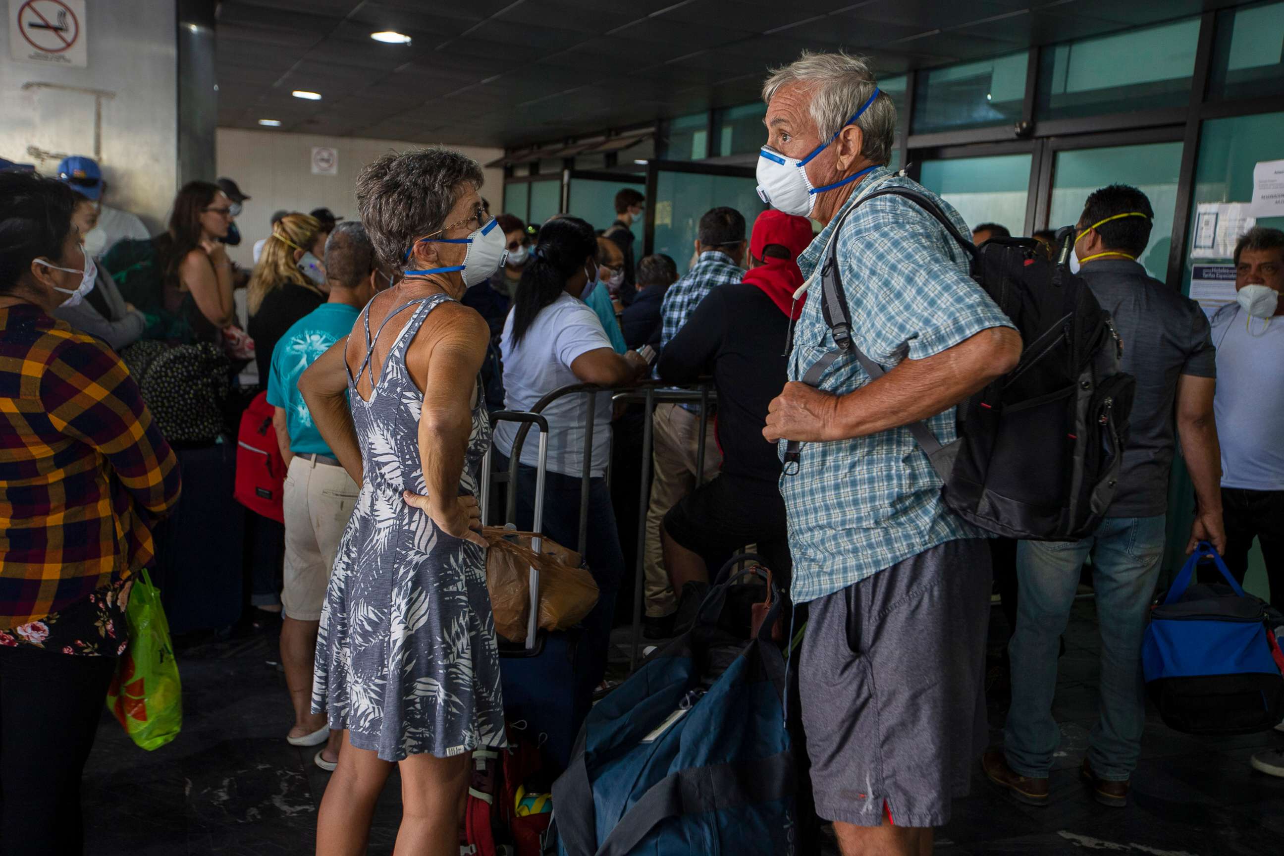 PHOTO: Travelers wait for a charter flight coordinated by the U.S. embassy at the La Aurora airport in Guatemala City, Tuesday, March 24, 2020.