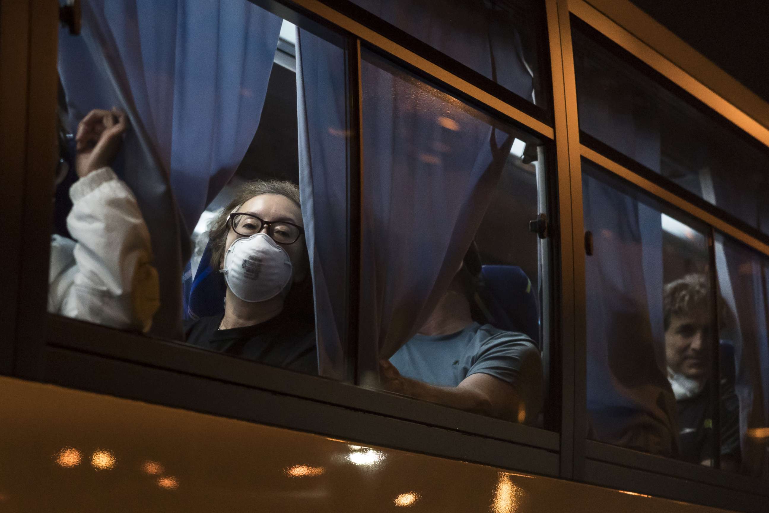 PHOTO: American citizens look out from a bus as they arrive at Haneda Airport in Tokyo, Japan, on Feb. 17, 2020.