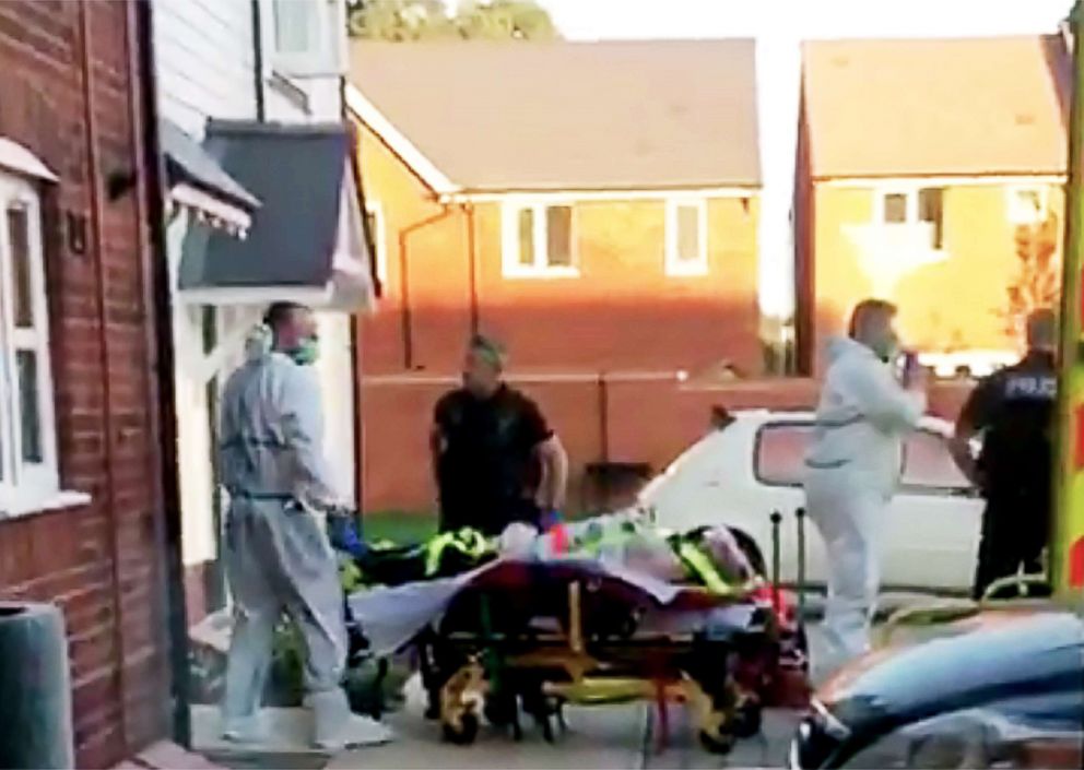 PHOTO: A still image taken from video footage recorded on June 30, 2018 shows a man on a stretcher being put into an ambulance by medics and police outside a residential address in Amesbury, southern England, on June 30, 2018.