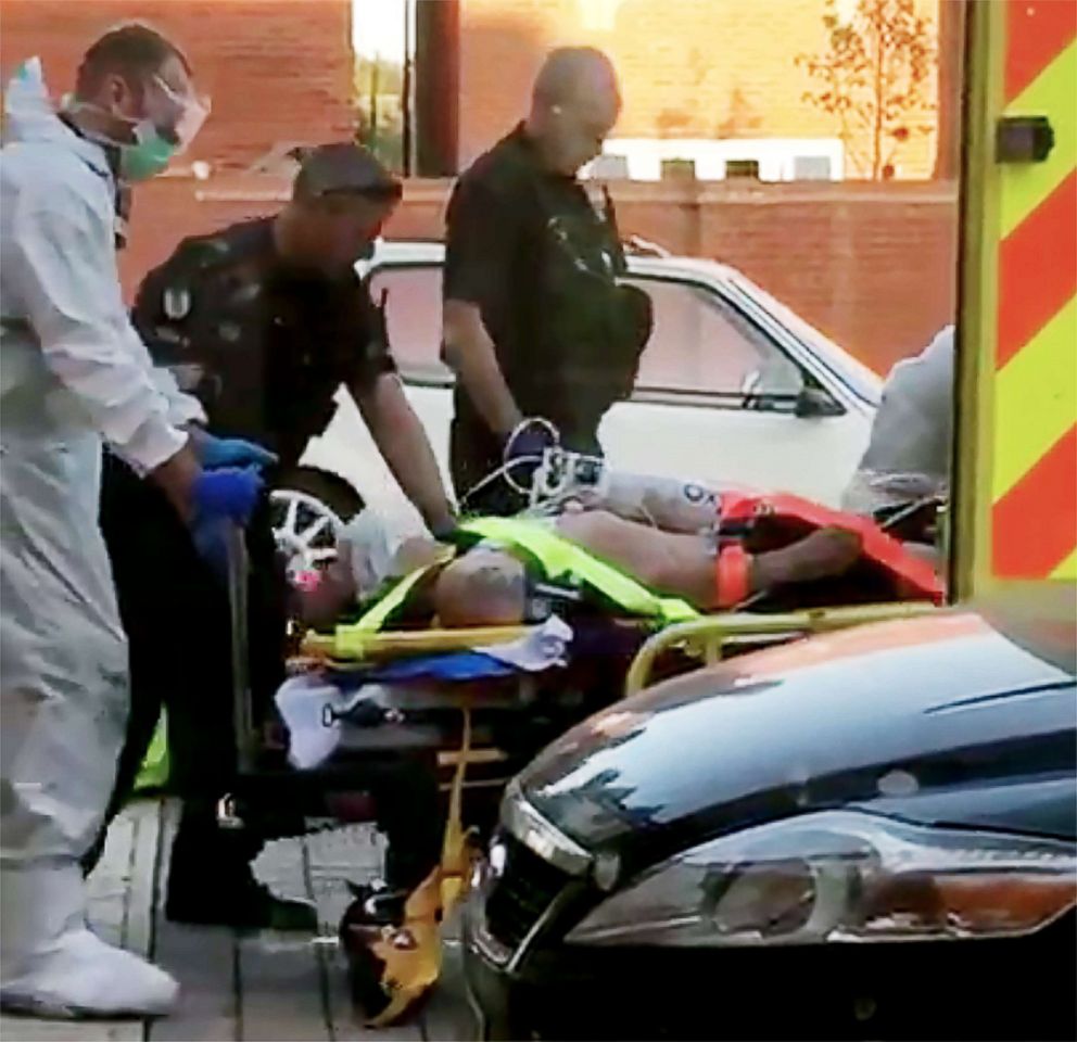 PHOTO: A still image taken from video footage recorded on June 30, 2018 shows a man on a stretcher being put into an ambulance by medics and police outside a residential address in Amesbury, southern England, on June 30, 2018.