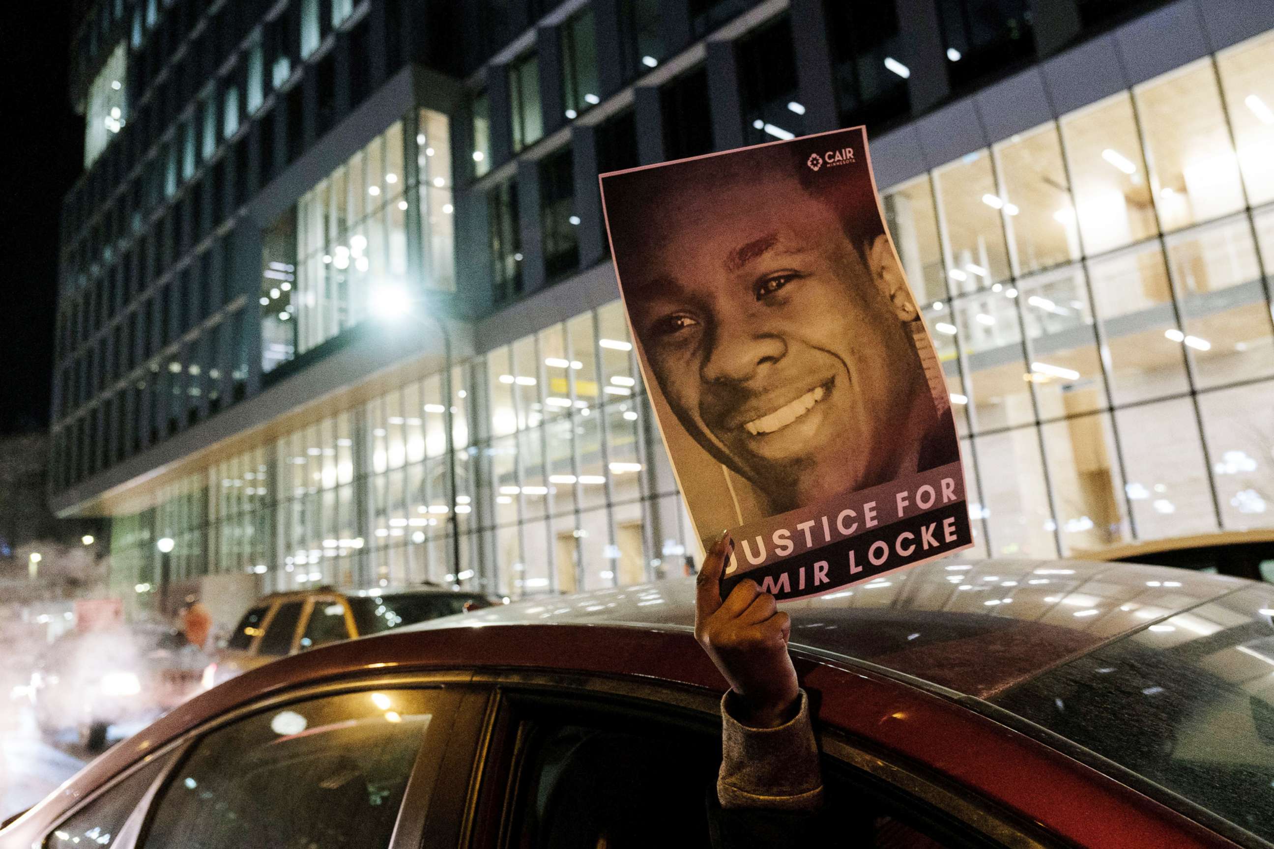 PHOTO: A demonstrator holds up a poster depicting Amir Locke, a Black man who was shot and killed by Minneapolis police's SWAT team, at a protest in Minneapolis, Feb. 4, 2022.