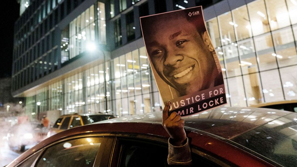 PHOTO: A demonstrator holds up a poster depicting Amir Locke, a Black man who was shot and killed by Minneapolis police's SWAT team, at a protest in Minneapolis, Feb. 4, 2022.