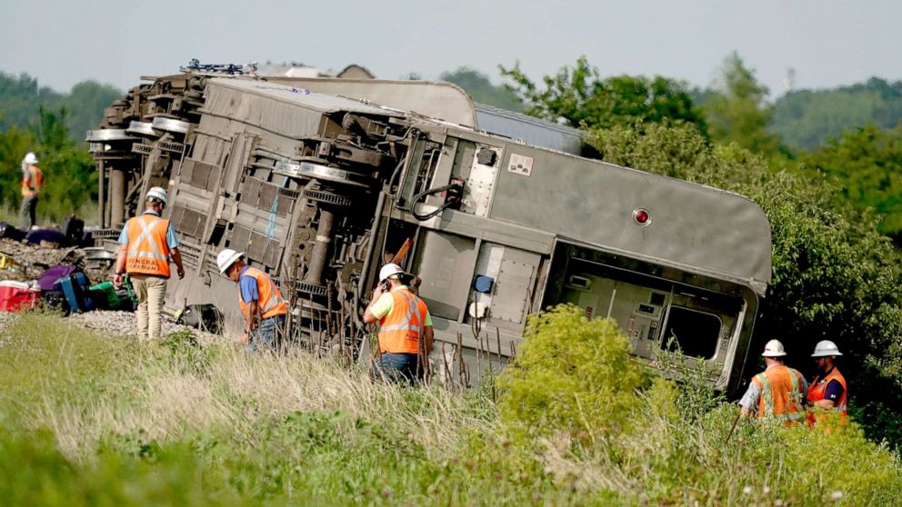 PHOTO: Workers inspect the scene of an Amtrak train which derailed after striking a dump truck near Mendon, Mo., June 27, 2022.