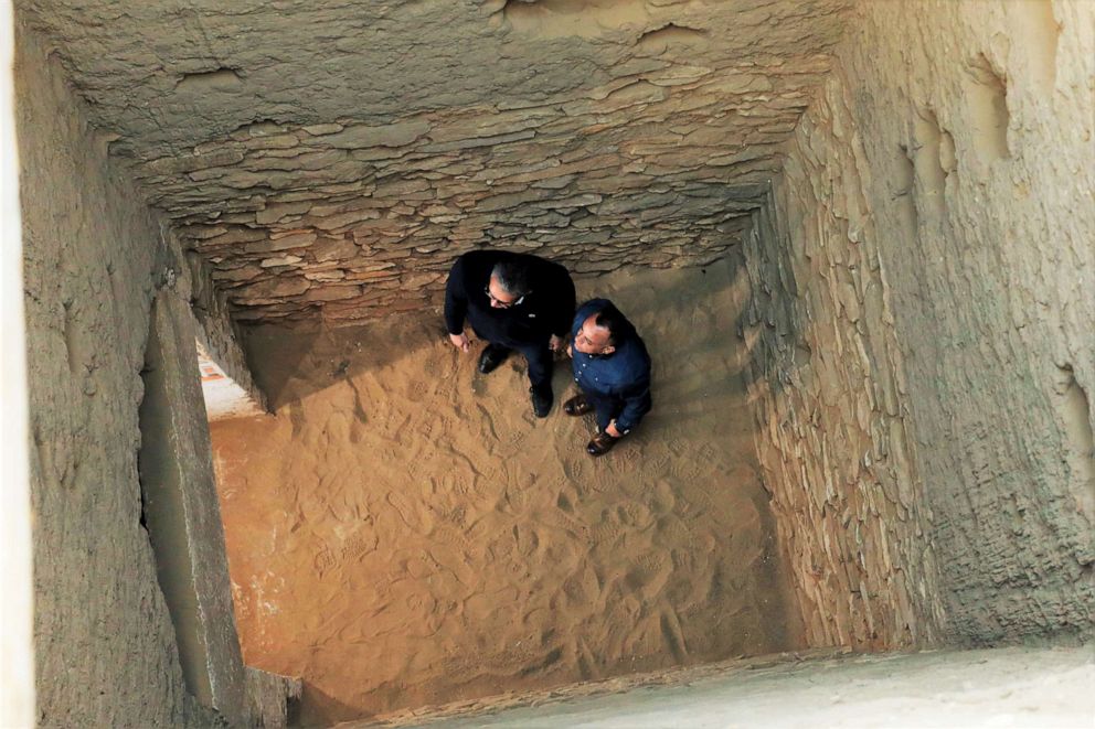 PHOTO: Egypt's antiquities and tourism minister, Khaled el-Anany, and Mostafa El-Waziri, the head of the country's Supreme Antiquities Council, inside one of the deep burial shafts in Saqqara, Egypt.