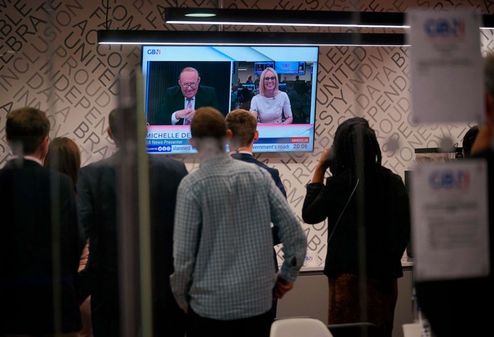 PHOTO: Staff in the green room watching a television screen showing presenters Andrew Neil and Michelle Dewberry broadcast from a studio, during the launch event for new TV channel GB News at The Point in Paddington, London, June 13, 2021.