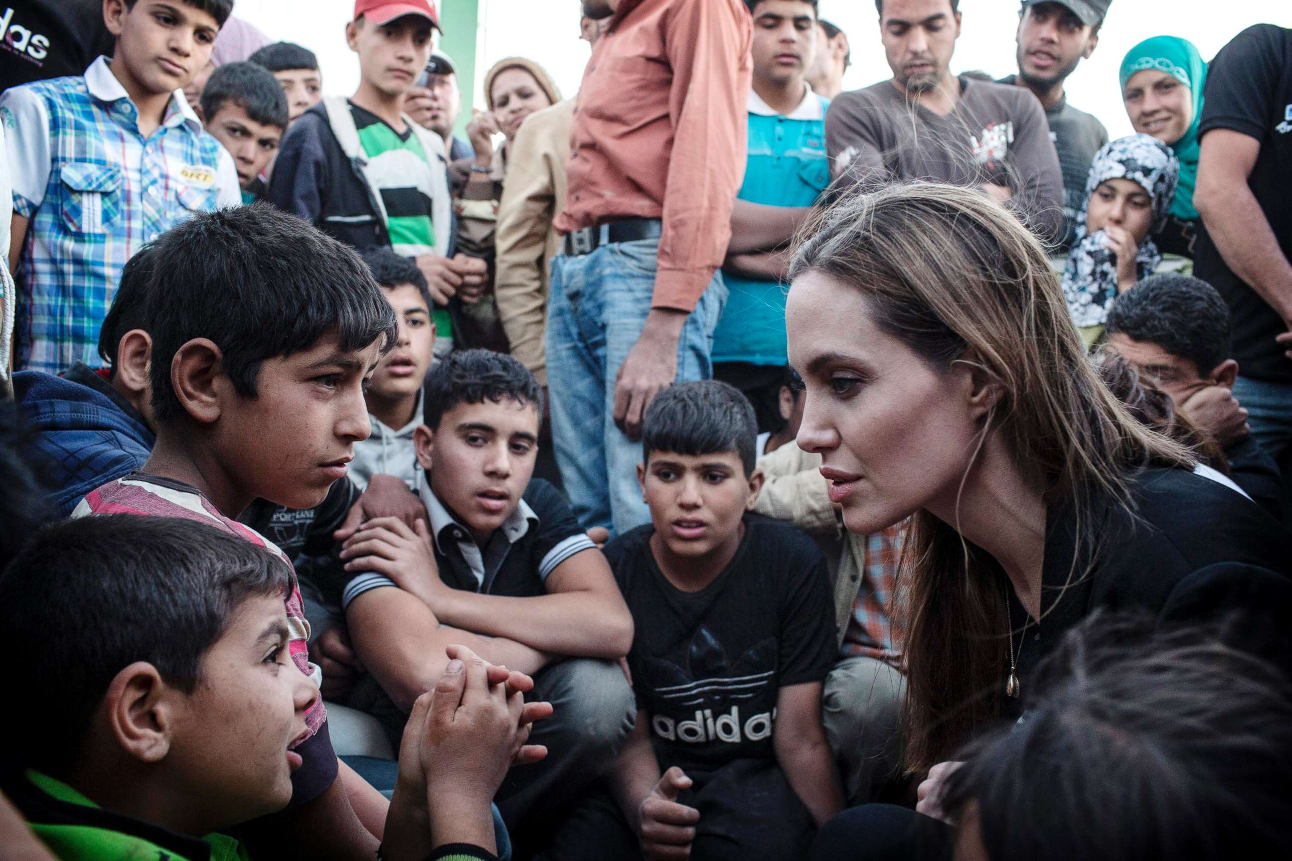 PHOTO: UNHCR Special Envoy Angelina Jolie speaks with Syrian refugees in a Jordanian military camp based near the Syria/Jordan border, June 18, 2013.