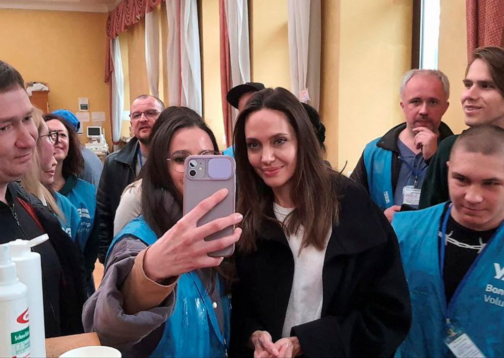 PHOTO: U.S. actor and UNHCR Special Envoy Angelina Jolie gets a selfie taken with a volunteer as she visits Lviv's main railway station, amid Russia's invasion of Ukraine, April 30, 2022, in this handout image.