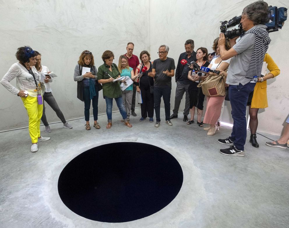 PHOTO:  Anish Kapoor talks to journalists inside the cube structure of "Descent into Limbo" during the presentation to the press of his exhibition "Anish Kapoor: Works, Thoughts, Experiments" in Serralves Museum and Park, in Porto, Portugal, July 6, 2018.