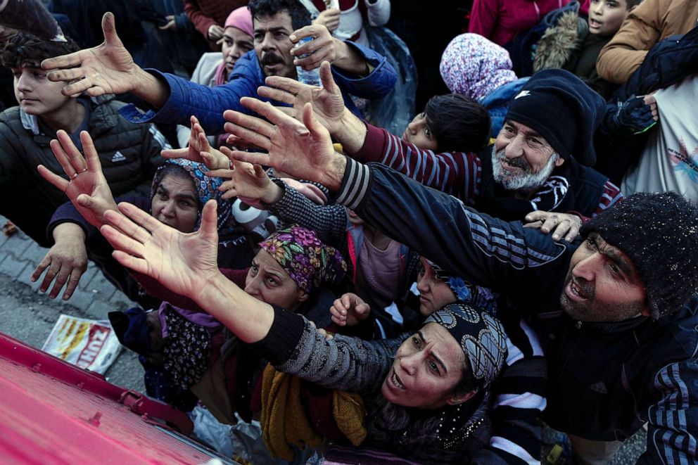 PHOTO: Volunteers distribute aid to people in Antakya, southern Turkey, Feb. 8, 2023.