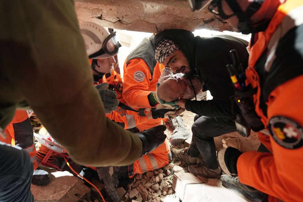PHOTO: Swiss rescue team handing over a four-month-old girl called Abir rescued from under the rubble of a collapsed building following a massive earthquake, Feb. 6, 2023, in Antakya, Turkey, Feb. 8, 2023.
