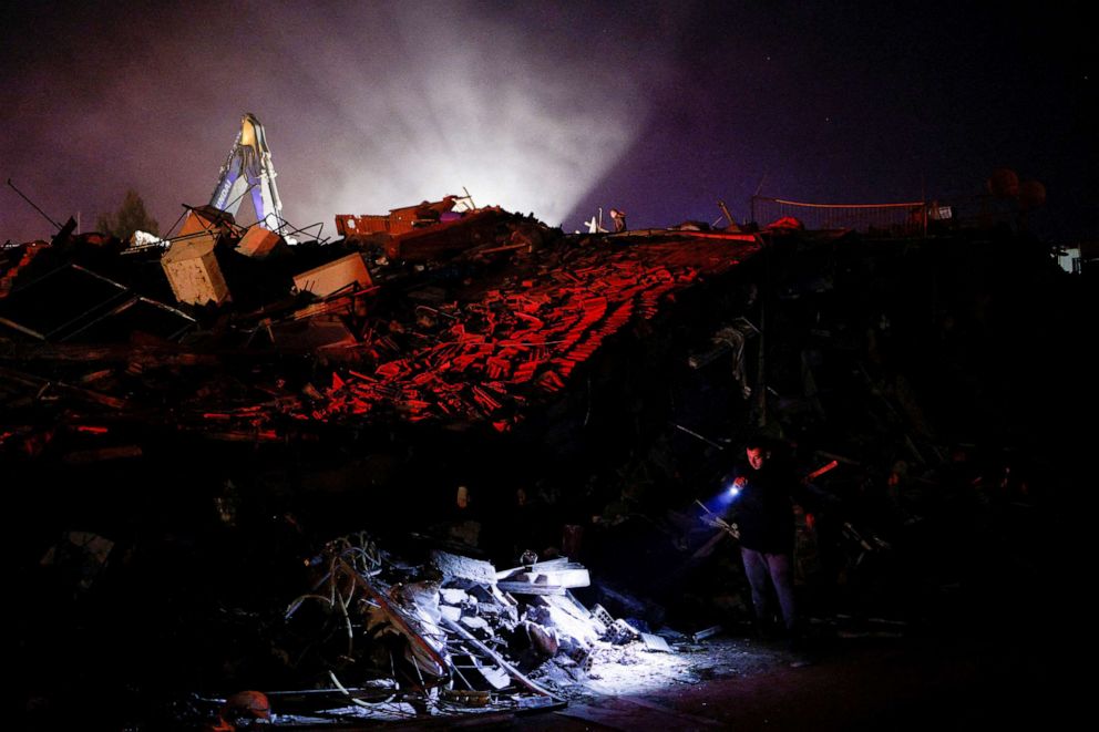 PHOTO: A man uses a lantern to check damaged buildings, in the aftermath of an earthquake, in Antakya, Turkey, Feb. 8, 2023.
