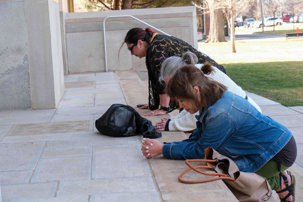 PHOTO: Anti-abortion protesters pray outside of the Potter County Courthouse in support of a case to stop medication abortion, in Amarillo, Texas, on March 15, 2023.