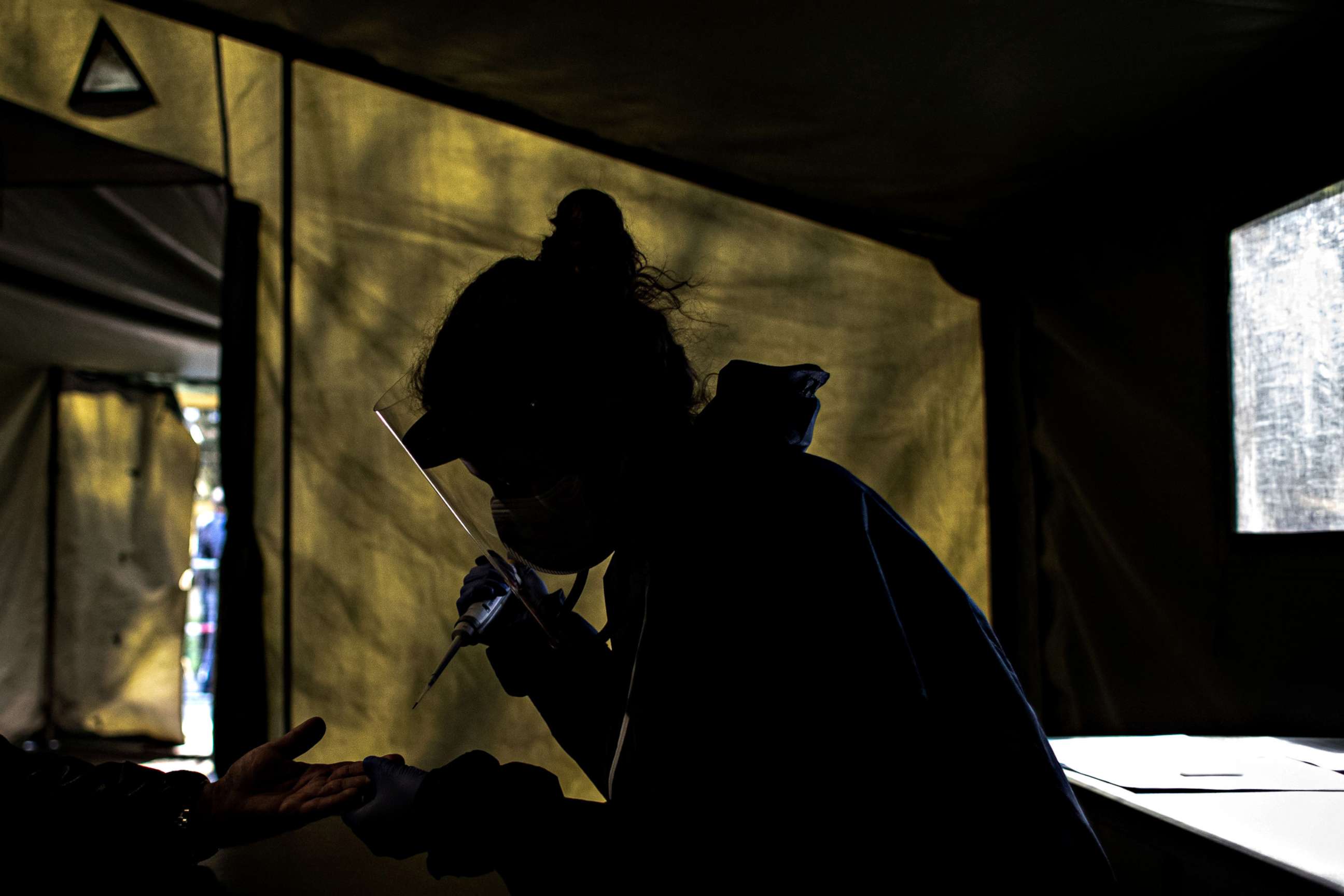 PHOTO: Medical staff takes a sample to test people for coronavirus antibodies in Prague, Czech Republic, April 23, 2020.