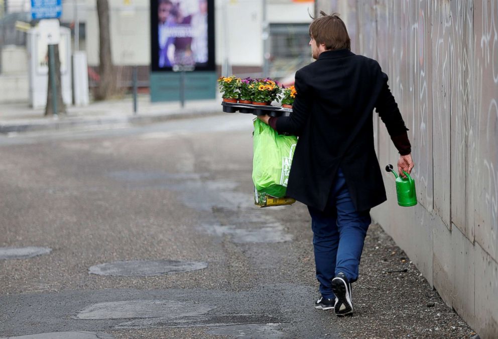 PHOTO: Brussels resident Anton Schuurmans looks for unrepaired potholes to plant flowers in as he walks around Brussels, Belgium, April 5, 2018.