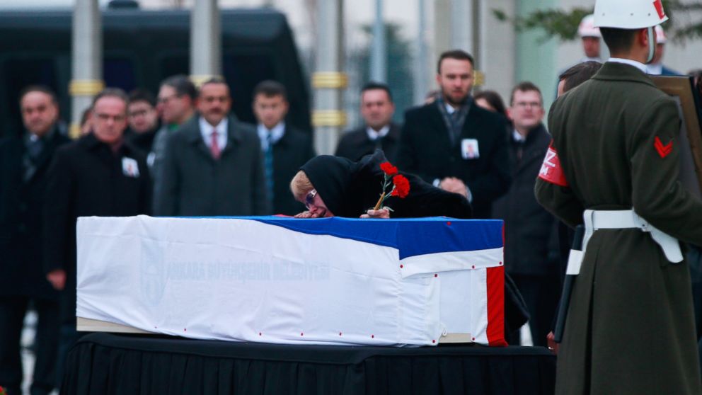 PHOTO: The wife of Russian Ambassador to Turkey Andrei Karlov cries over her husband's coffin during a ceremony at the airport in Ankara, Turkey, Dec. 20, 2016.