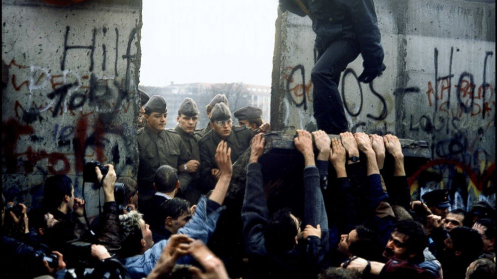 PHOTO: East German border guards are pictured through the gap after crowds tear down a section of the Berlin Wall in Germany, Nov. 10, 1989. 