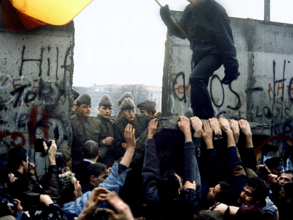 PHOTO: East German border guards are pictured through the gap after crowds tear down a section of the Berlin Wall in Germany, Nov. 10, 1989. 