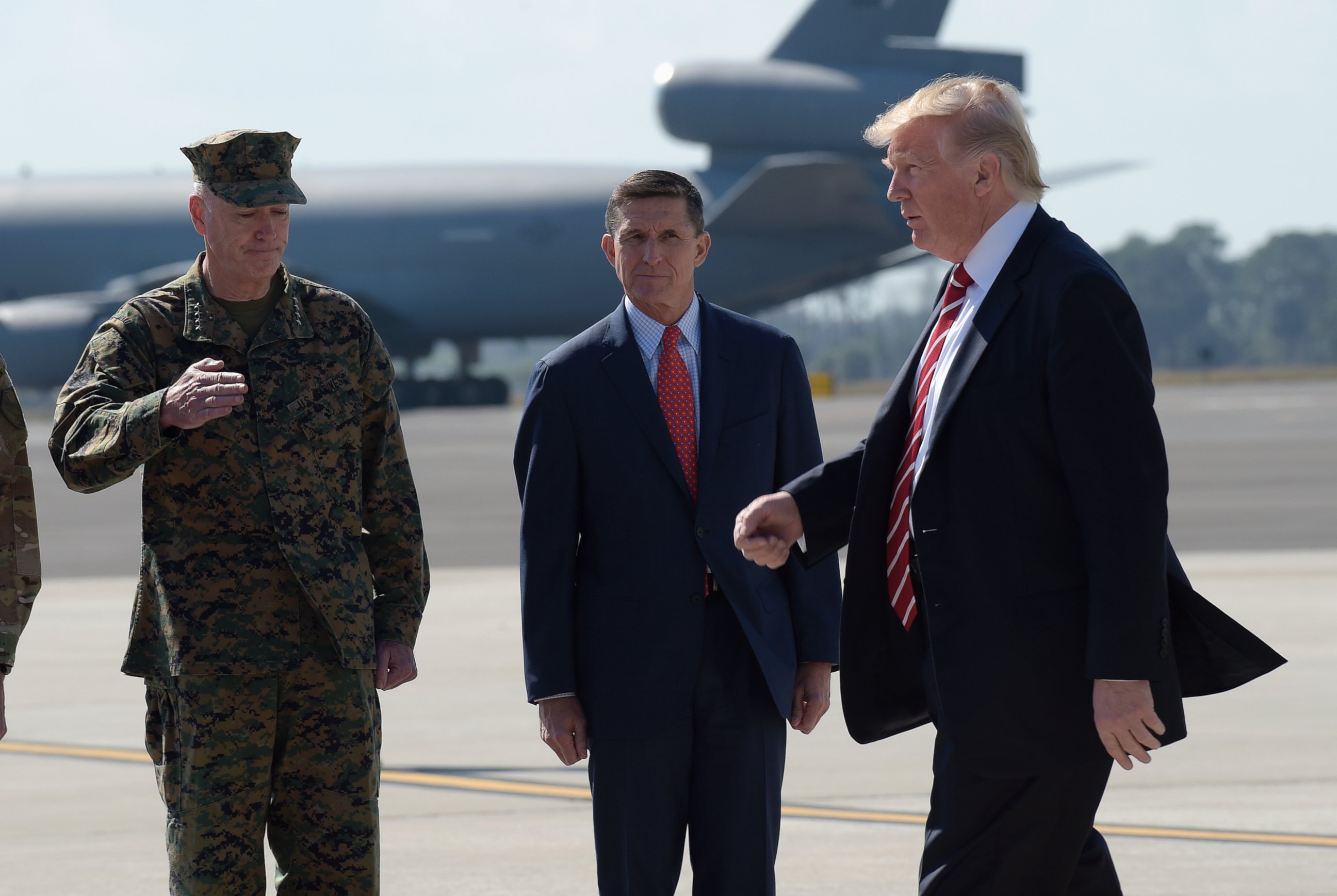 PHOTO: President Donald Trump passed Joint Chiefs Chairman Gen. Joseph Dunford, left, and National Security Adviser Michael Flynn as he arrives via Air Force One at MacDill Air Force Base in Tampa, Florida, Feb. 6, 2017. 