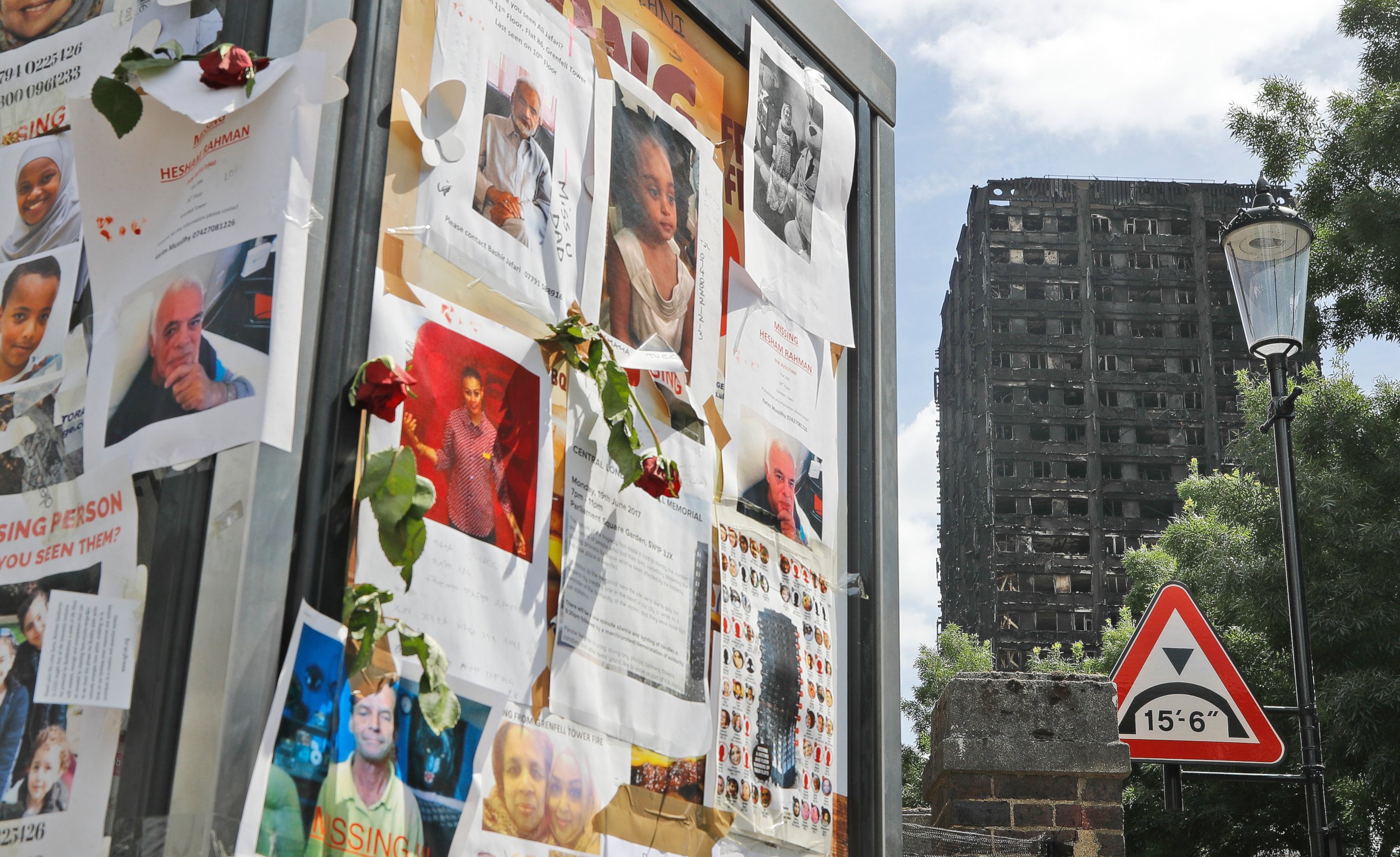 PHOTO: Pictures of missing people on a message board near to the burnt Grenfell Tower apartment building in London, June 23, 2017.