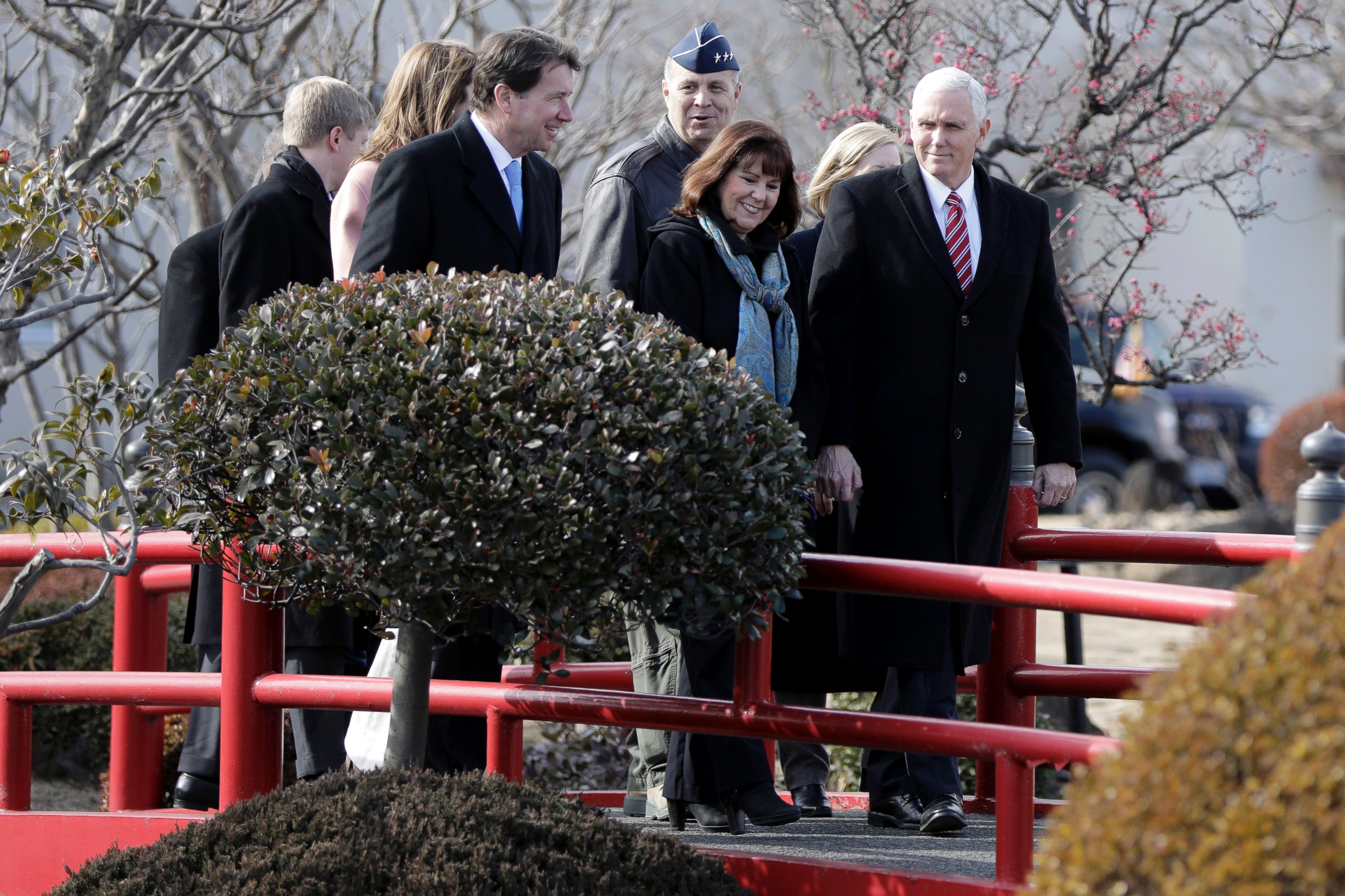U.S. Vice President Mike Pence, right, and his wife Karen Pence, center, walk through U.S. Yokota Air Base, on the outskirts of Tokyo, Thursday, Feb. 8, 2018. 