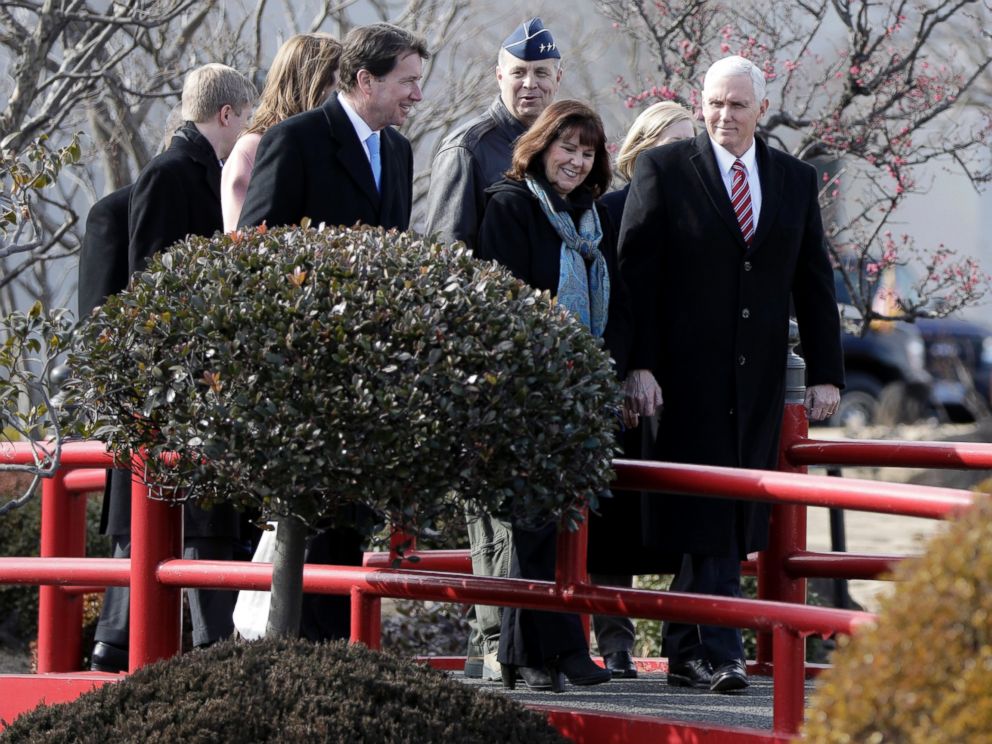 U.S. Vice President Mike Pence, right, and his wife Karen Pence, center, walk through U.S. Yokota Air Base, on the outskirts of Tokyo, Thursday, Feb. 8, 2018.