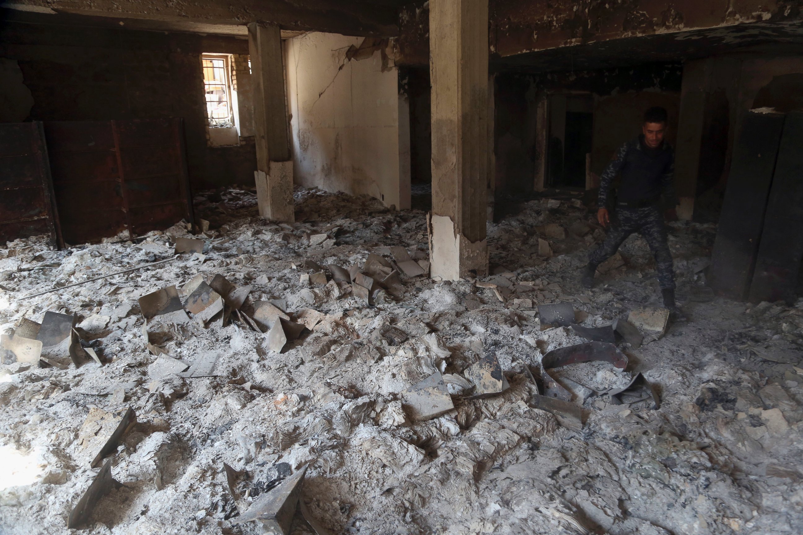 PHOTO: The charred remains of ancient books and manuscripts that had been burned are seen inside Mosul's heavily damaged museum in Western Mosul, Iraq, March 8, 2017.