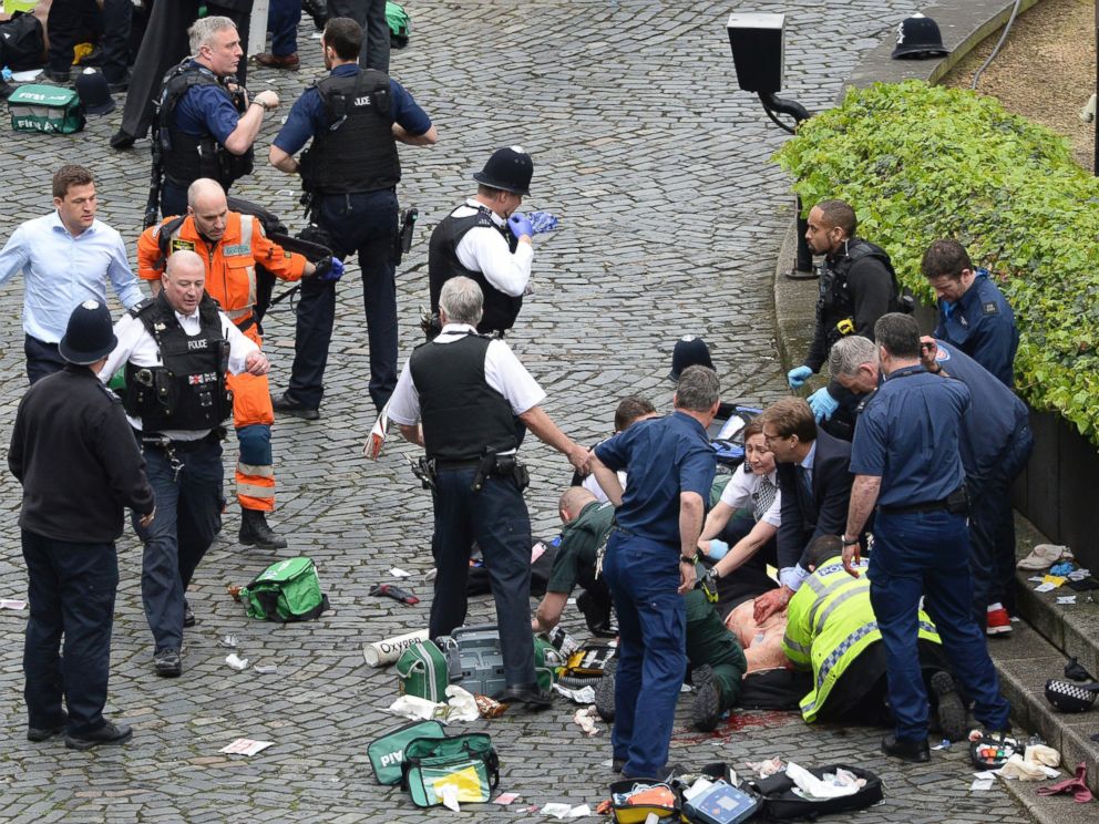 PHOTO: Emergency services assist a person on the ground at the scene of an incident outside the Palace of Westminster in London, March 22, 2017.