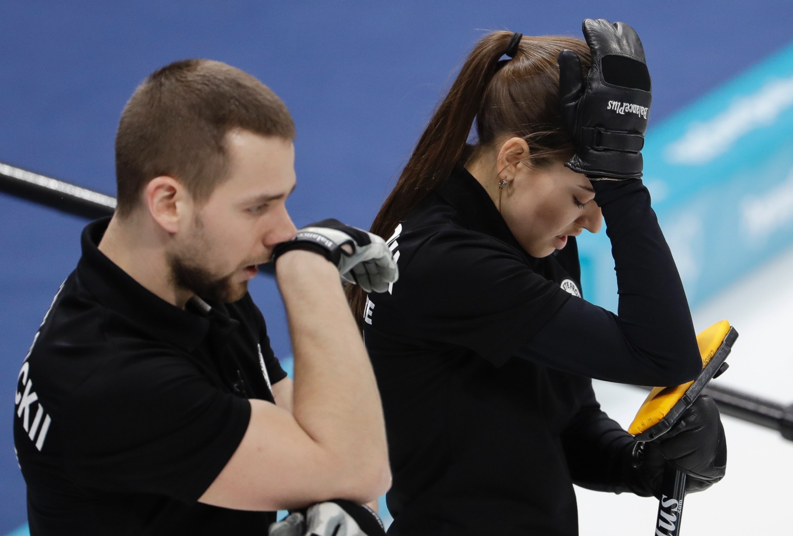 Russian athletes Anastasia Bryzgalova, right, and Aleksandr Krushelnitckii look down during the mixed doubles semi-final curling match against Switzerland Jenny Perret and Martin Rios at the Winter Olympics in South Korea, Monday, Feb. 12, 2018.