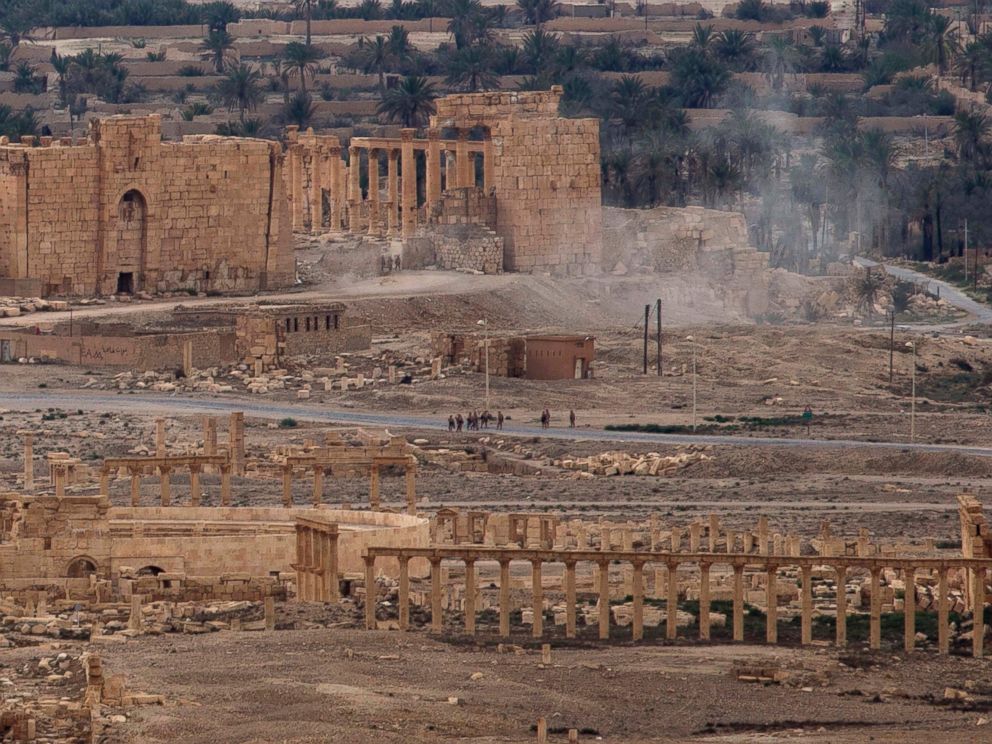 PHOTO: Russian soldiers stand on a road as smoke rises from a controlled land mine detonation by Russian experts inside the ancient town of Palmyra, Syria in the central Homs province, April 14, 2016.