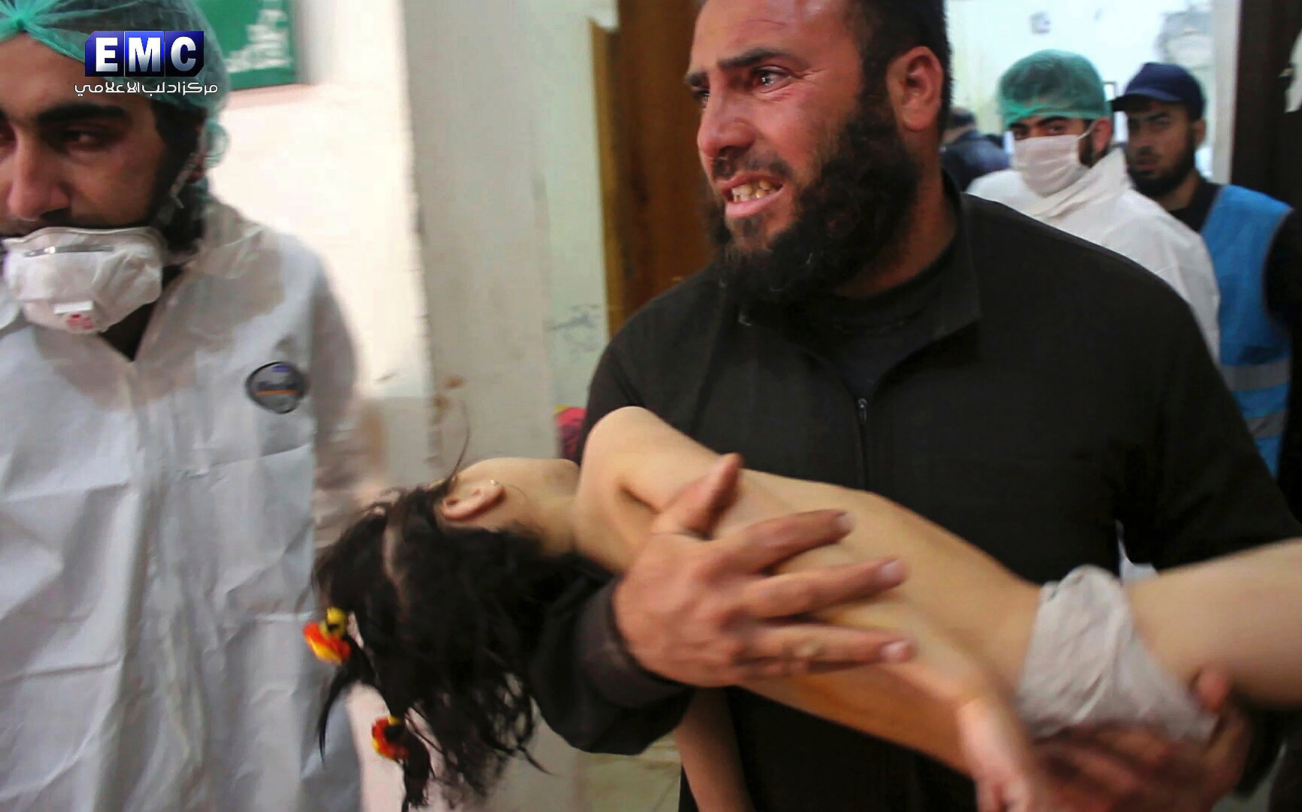 PHOTO: A man carries a child following a suspected chemical attack inside a makeshift hospital in the town of Khan Sheikhoun, northern Idlib province, Syria, April 4, 2017.