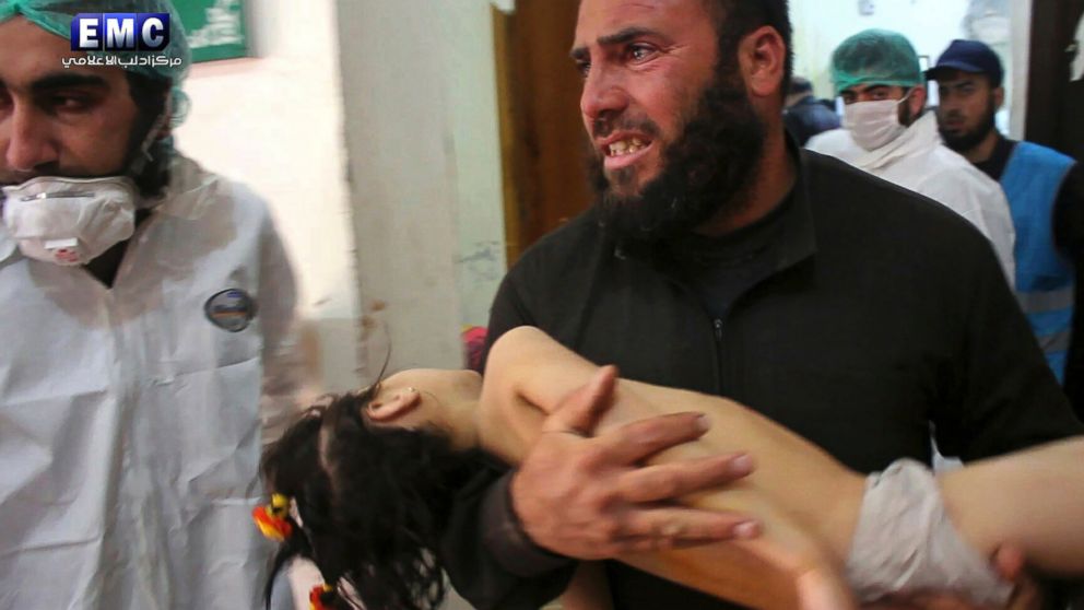 A man carries a child following a suspected chemical attack inside a makeshift hospital in the town of Khan Sheikhoun, northern Idlib province, Syria, April 4, 2017, in a photo provided by the Syrian anti-government activist group Edlib Media Center.