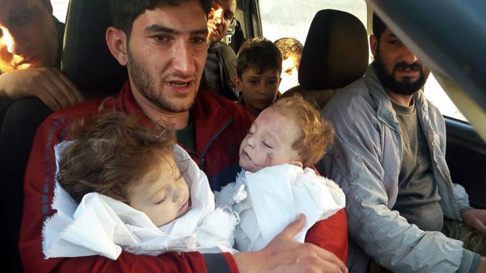 In this picture taken on Tuesday April 4, 2017, Abdel Hameed al-Youssef, 29, holds his twin babies who were killed during a suspected chemical weapons attack, in Khan Sheikhoun in the northern province of Idlib, Syria.