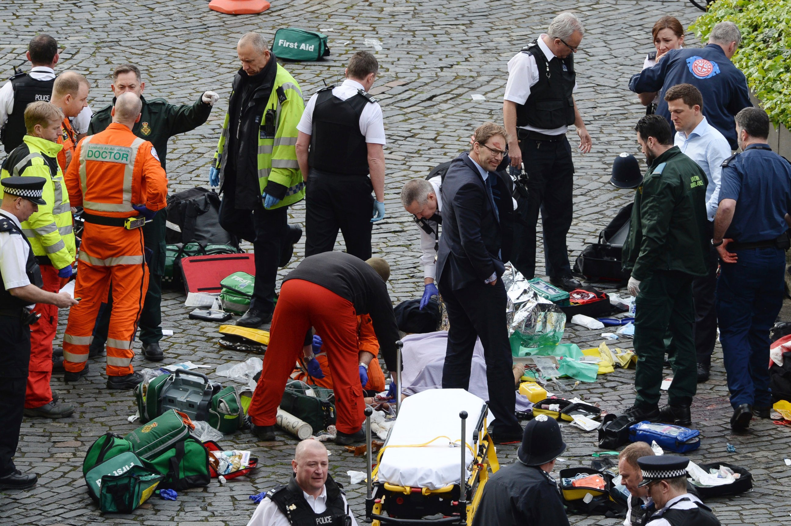 PHOTO: Conservative MP Tobias Ellwood stands among the emergency services at the scene outside the Palace of Westminster, London, March 22, 2017.