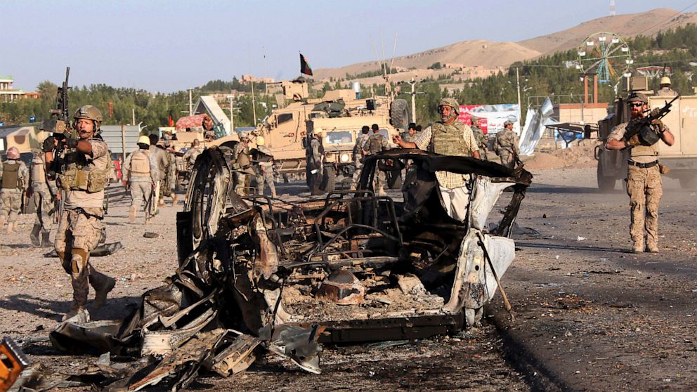 U.S.-led troops investigate the site of a suicide car bombing and a gunfight near the U.S. consulate in Herat Province, west of Kabul, Afghanistan, Friday, Sept. 13, 2013.