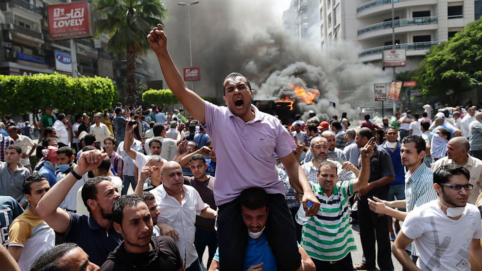 Supporters of Egypt's ousted President Mohammed Morsi chant slogans against Egyptian Defense Minister Gen. Abdel-Fattah el-Sissi during clashes with Egyptian security forces in Cairo's Mohandessin neighborhood, Egypt, Wednesday, Aug. 14, 2013. 
