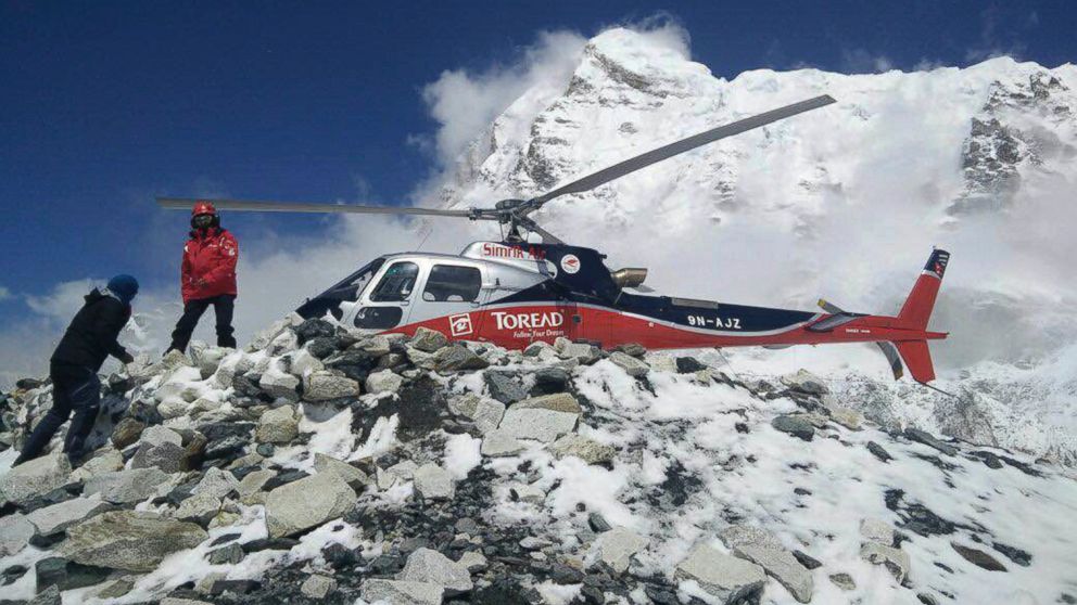 PHOTO: In this photo provided by Azim Afif, a helicopter prepares to rescue people from camp 1 and 2 at Everest Base Camp, Nepal, April, 27, 2015.